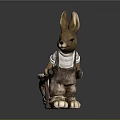 Brown Rabbit Figurine With Long Ears Wearing White Shirt And Overalls Standing On Dark Background