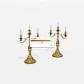Decorative Golden Candelabras With Multiple Candle Arms And Ornate Bases