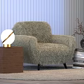 Globe Table Lamp On Wooden Side Table Next To Fluffy Chair With Books And Vase