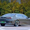 Modern Gray Luxury Electric Sedan With Blue Alloy Wheels And Natural Outdoor Background