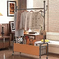 Metal Clothes Rack With Hanging Clothes And Storage Basket In Indoor Setting With Wooden Furniture