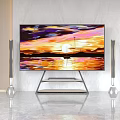 TV on Modern Stand Showing Sunset Landscape with Floor Speakers and Marble Wall