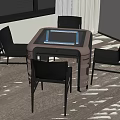 Contemporary Dining Table With Glass Top And Four Black Chairs In Bright Room