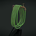 Brass Faucet with Green Coiled Hose on Dark Background and Shadow Detail