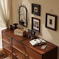 Ornamental Decoration Collection with Decorative Mirror Photo Frames Open Book and Lamp on Wooden Dresser