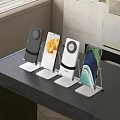 Different Color Phone Stands Holding Mobile Phones On Black Desktop Setup