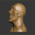 Golden Human Head Sculpture With Exaggerated Smile And Textured Surface On Dark Background