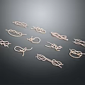 Gold Tone Metal Knot Ornaments In Various Shapes On Black Background