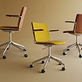 Three Modern Office Chairs With Yellow Brown Upholstery Armrests And Casters