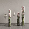 Pink Tulips in Glass Vases with Various Heights and Transparent Candle Holders on Dark Table