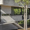 Modern Vacation Rental Building With Concrete Cantilevered Design Surrounded By Trees And Large Windows
