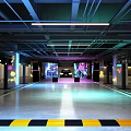 Modern Parking Garage With Colorful LED Lighting Sleek Ceiling And Reflective Floor