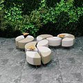 Modern Outdoor Chairs With Curved Design On Gray Stone Floor And Lush Greenery Backdrop