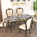 Elegant Carved Dining Table Set With Gold Accents Chandelier And Green Plant