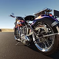 Vintage Yellow And Black Motorcycle With Flame Graphics On Open Road Under Sky