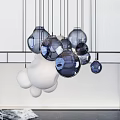 Multiple White Spherical Pendant Lights Hanging Against Light Colored Background 3d model