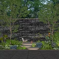 Modern Courtyard Garden With Waterfall Wall Trees Lush Plants Comfortable Chair And Warm Lighting