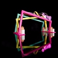Colorful Geometric Frame Structure With Neon Lights And Reflection On Black Background