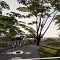 Park Landscape Featuring Modern Viewing Platform Lush Green And Red Leaved Trees Winding Path Visitors