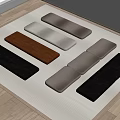 Various Colored Textured Long Cushions Neatly Arranged on Light Mat with Wooden Floor