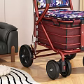 Red Frame Rollator Walker With Floral Seat And Storage Baskets In Indoor Setting 3d model
