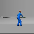 Man wearing blue work uniform and orange safety helmet holding green tool with black cable