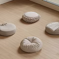 Soft Round Floor Cushions with Various Designs on Light Wooden Floor
