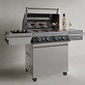 Outdoor Stainless Steel Grill With Wine Bottle Glasses And Grilled Food