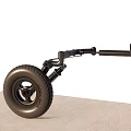 Black Tire With Rim Connected To Spring Support Mechanism On Gray Surface