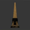 Tall Golden Topped Obelisk With Black Base And Ornate Decorative Elements