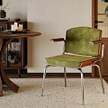 Green Velvet Accent Chair With Metal Frame In Modern Interior With Wooden Table And Plant