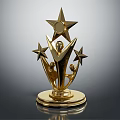 Shiny Golden Trophy Featuring Large Star And Two Small Stars With Human Figures On Base