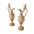 Pair of Ornate Golden Decorative Pitchers With Intricate Carvings And Sculpted Handles