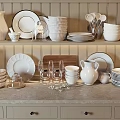 White Ceramic Dinnerware Set With Plates Bowls Pitchers And Glasses On Kitchen Shelf Countertop