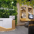 Bridal Shop Interior With Greenery Wall Marble Counter And Lighted Vanity Mirrors