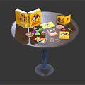 Round Wooden Table Displaying Yellow Boxes Cards CDs And Small Items 3d model