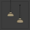 Two Cream Colored Shade Pendant Lights With Silver Bases Suspended By Black Chains Against Gray Wall