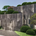 Natural Textured Stone Wall Landscaped With Trimmed Bushes And Green Trees