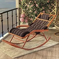Wicker Rocking Armchair With Wooden Frame Striped Cushion On Balcony With Flowers