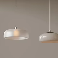 Two White Dome Shaped Pendant Lights Hanging With Metal Fixtures On Gray Background