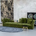 Green Velvet Sectional Sofa with Marble Textured Wall Colorful Decorative Plates and Round Area Rug