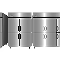 Stainless Steel Commercial Kitchen Appliances Arranged Side by Side in White Tiled Kitchen