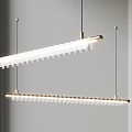 Modern Linear Chandelier With White Cylindrical Shades And Gold Metal Frame Hanging In Interior