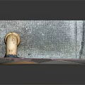 Orange Curved Pipe On Brick Floor With Textured Wall And Metal Grate