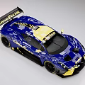 Blue And Yellow Monster Race Car With Aerodynamic Design And Rear Wing