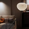 Modern White Floor Lamp In Cozy Living Room With Beige Sofa And Orange Pillow
