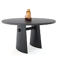 Round Black Dining Table With Unique Base Design And Decorative Brown Bottle Cups 3d model