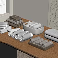 Soft Gray and Brown Towels Folded and Rolled on Wooden Table with Trays