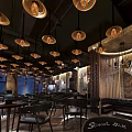 Modern Bar Interior With Vintage Pendant Lights Round Wooden Tables And Wine Racks