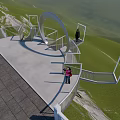 Modern Curved Viewing Platform With Glass Railings On Hilltop Grass And Rocks